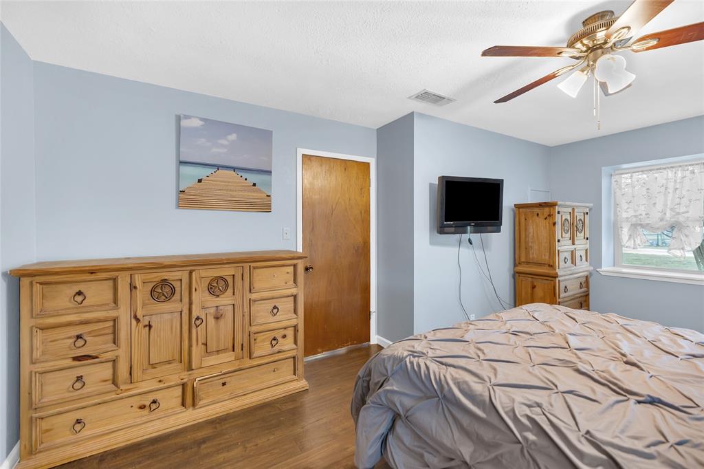 1900 Farm To Market 590, Unit A Zephyr, TX 76890 - Photo 16 of 40 a bedroom with a bed a flat tv screen and dresser