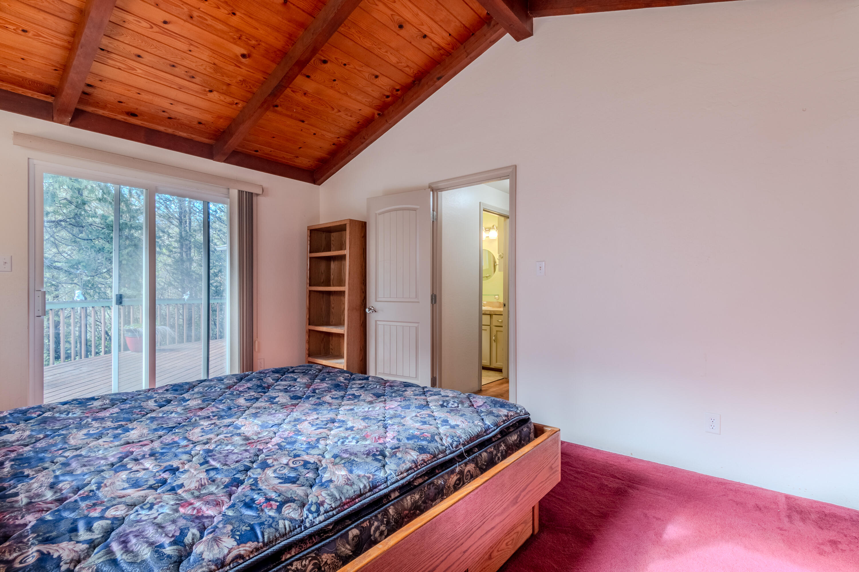 10950 Ramsey Road Gold Hill, OR 97525 - Photo 21 of 59 Primary Bedroom with sliding glass door to deck