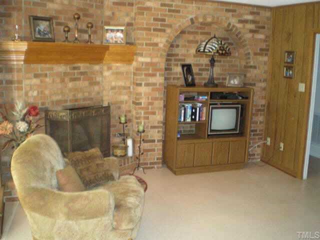 1606 Medfield Road Raleigh, NC 27607 - Photo 8 of 10 a living room with furniture and a fireplace