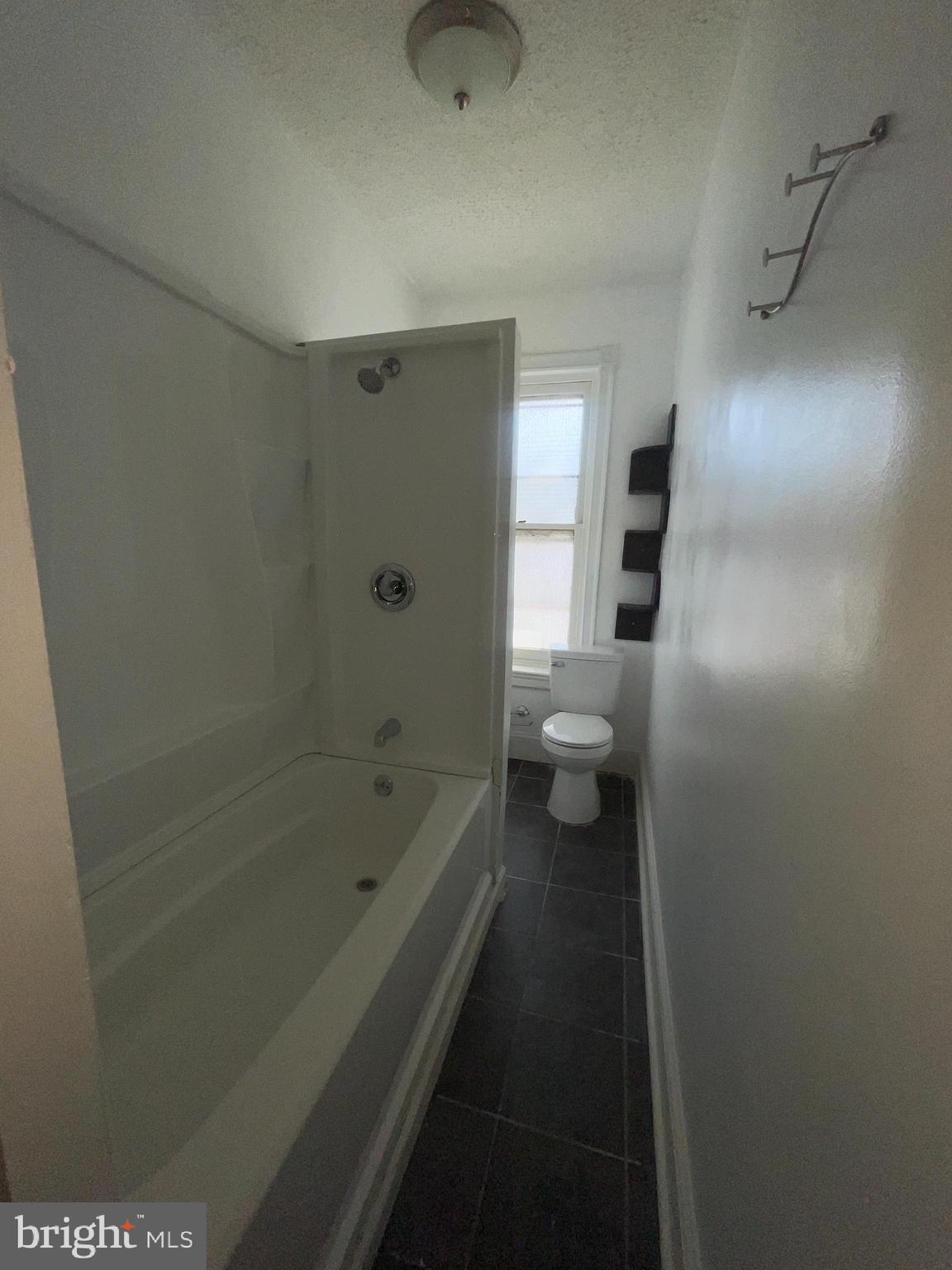 7611 Ridge Avenue, Unit 2 Philadelphia, PA 19128 - Photo 13 of 16 a bathroom with a bathtub and a toilet