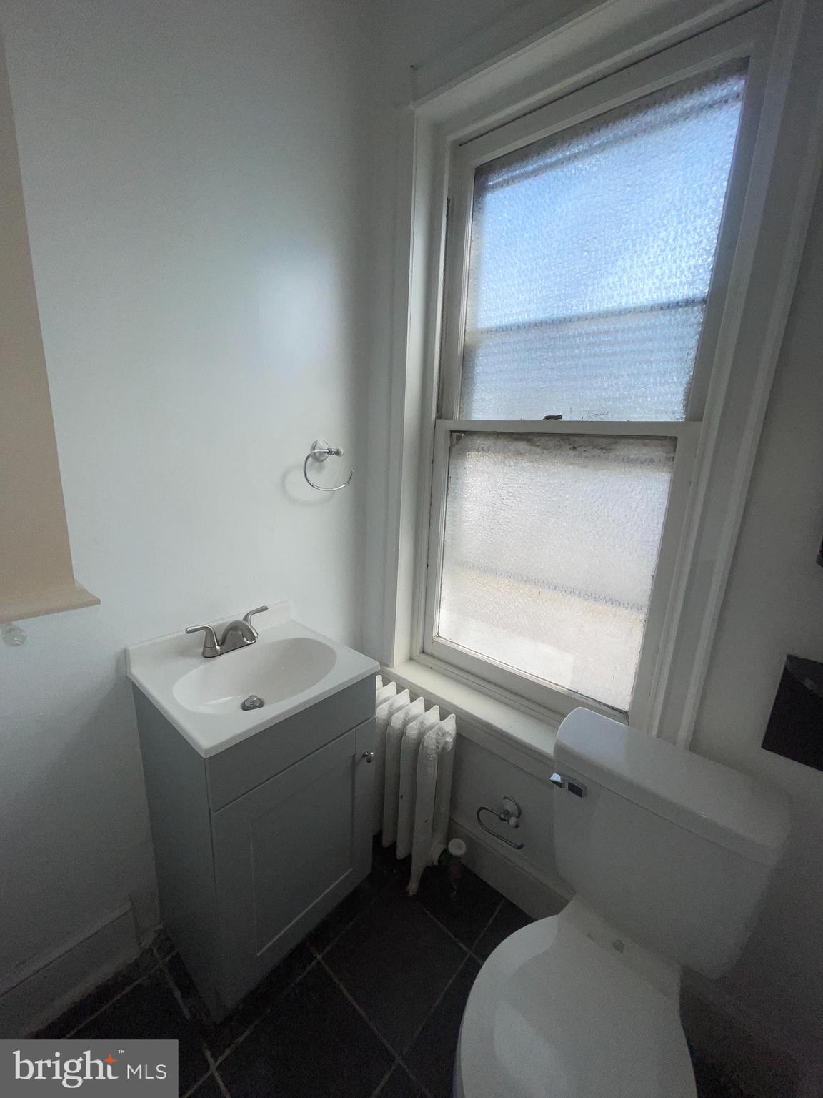 7611 Ridge Avenue, Unit 2 Philadelphia, PA 19128 - Photo 14 of 16 a bathroom with a sink toilet and window