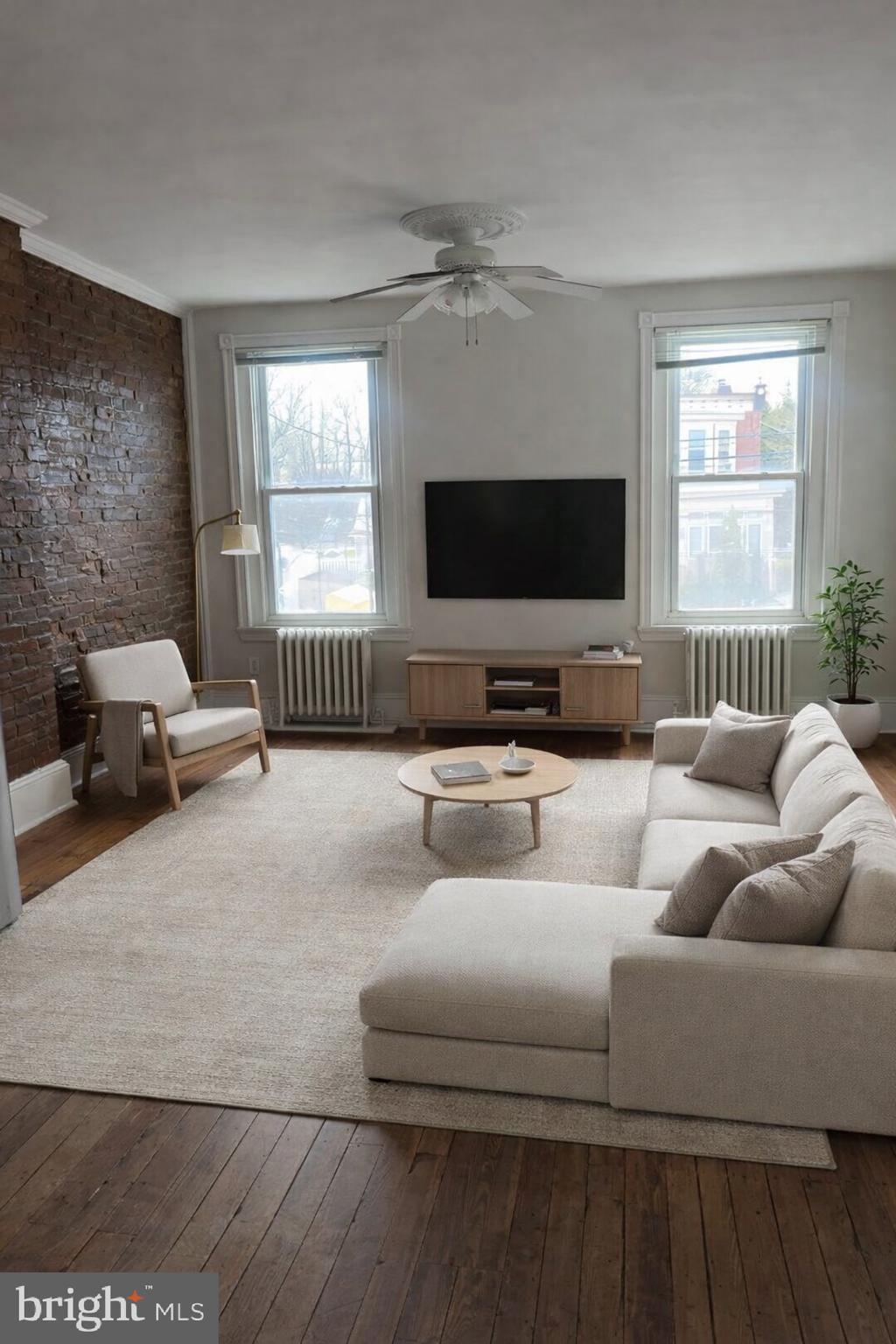 7611 Ridge Avenue, Unit 2 Philadelphia, PA 19128 - Photo 3 of 16 a living room with furniture and a flat screen tv