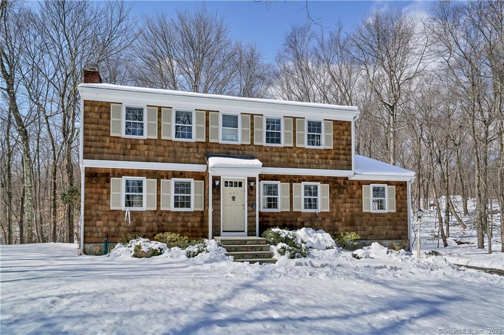 30 Woodchuck Lane Ridgefield, CT 06877 - Photo 1 of 1 a front view of a house with yard and seating space