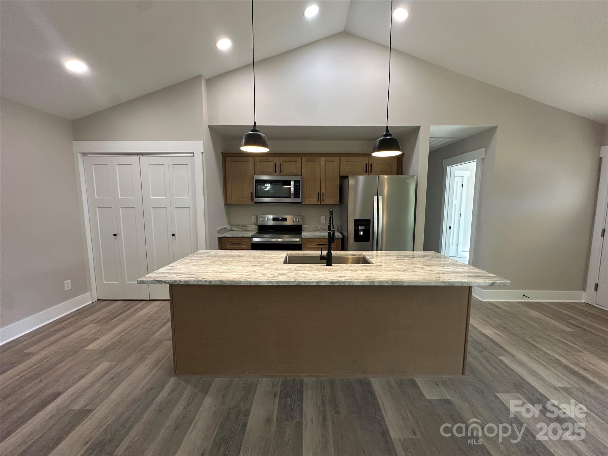 3537 Taxahaw Road Lancaster, SC 29720 - Photo 2 of 8 a view of kitchen with kitchen island a sink wooden floor and a living room view