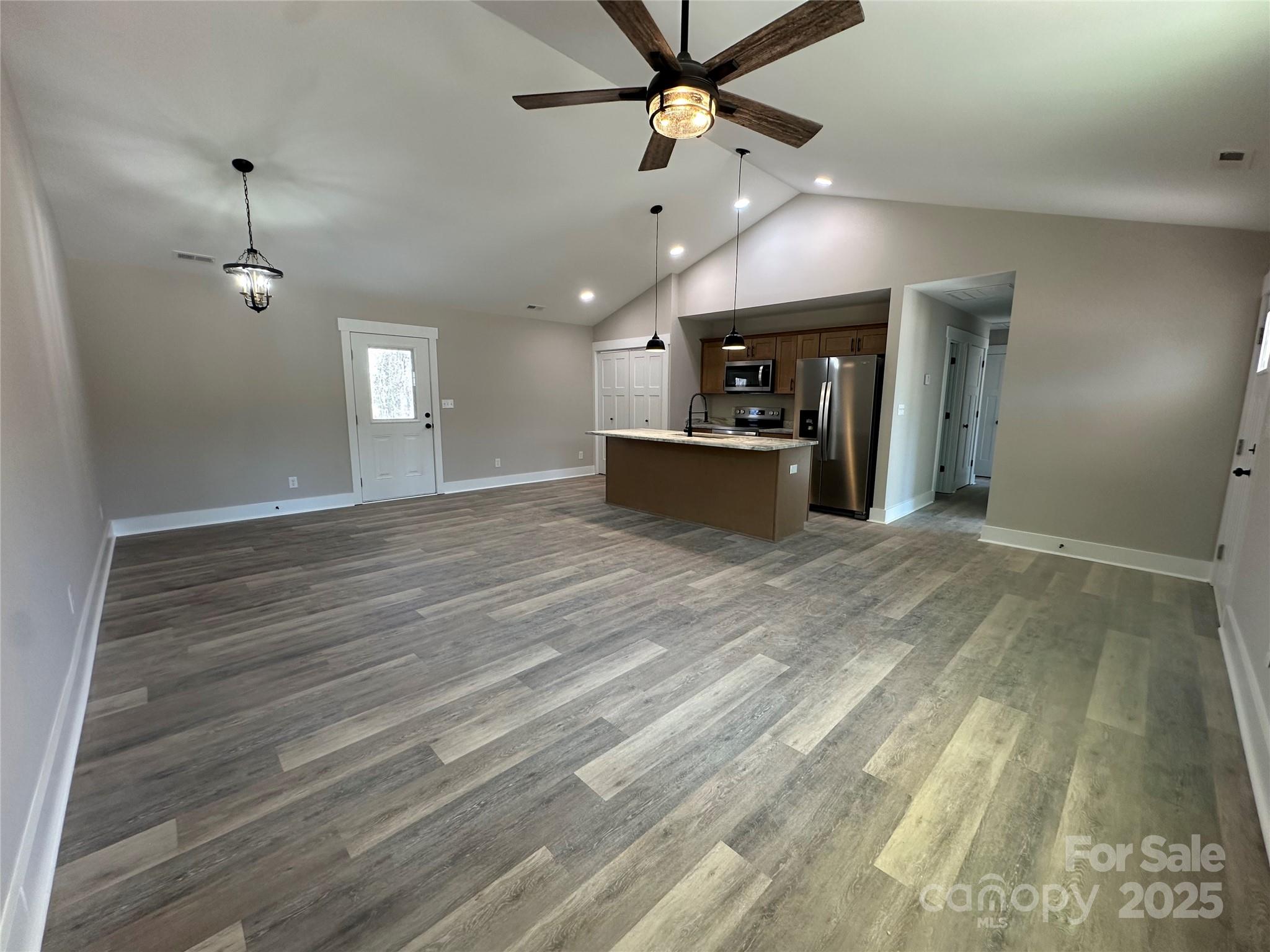 3537 Taxahaw Road Lancaster, SC 29720 - Photo 3 of 8 an empty room with wooden floor ceiling fan and windows