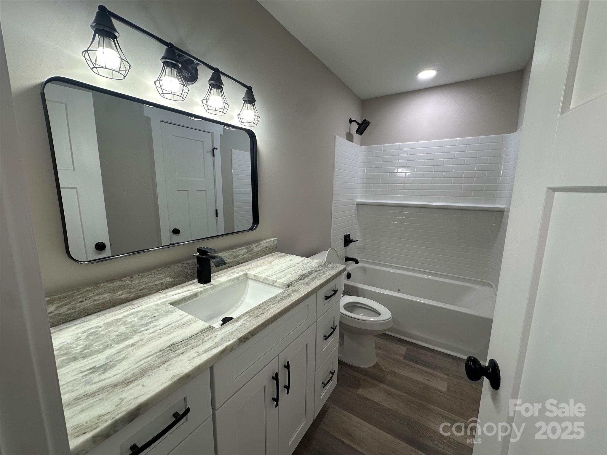 3537 Taxahaw Road Lancaster, SC 29720 - Photo 7 of 8 a bathroom with a granite countertop sink a toilet and a mirror