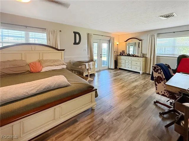 a bedroom with a bed window and a rug