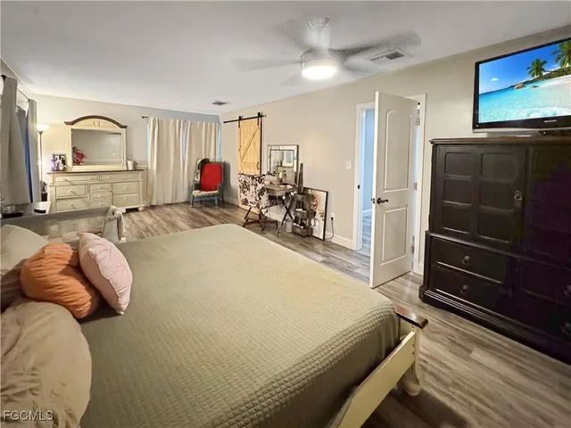 a bedroom with a bed and walk in closet