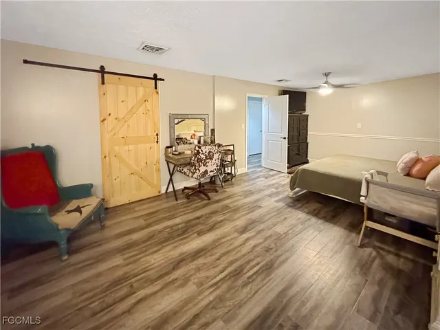 a bedroom with furniture and wooden floor