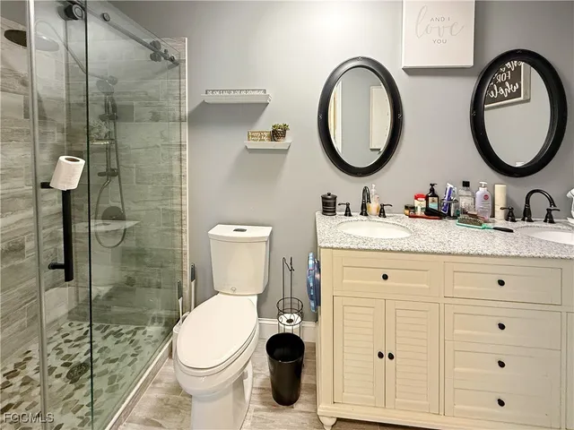 a bathroom with a toilet sink and a mirror
