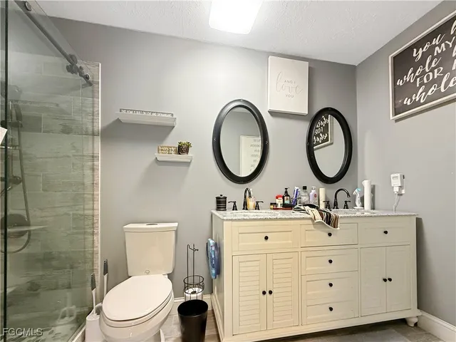 a bathroom with a toilet sink and a mirror