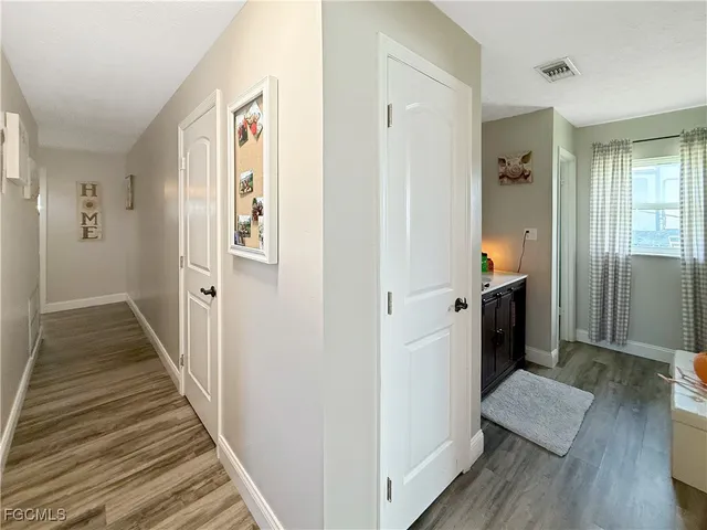 a view of a hallway with wooden floor and staircase