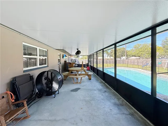 a living room with furniture and a floor to ceiling window