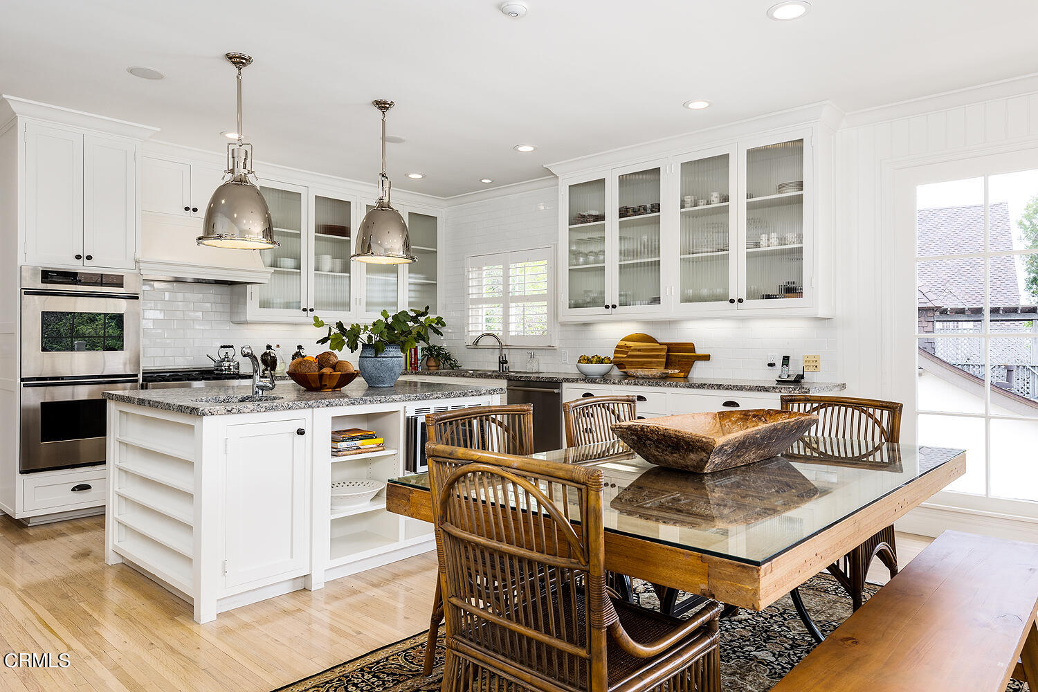 780 Huntington Circle Pasadena, CA 91106 - Photo 22 of 55 a kitchen with stainless steel appliances granite countertop a stove a sink dishwasher a dining table and chairs with wooden floor