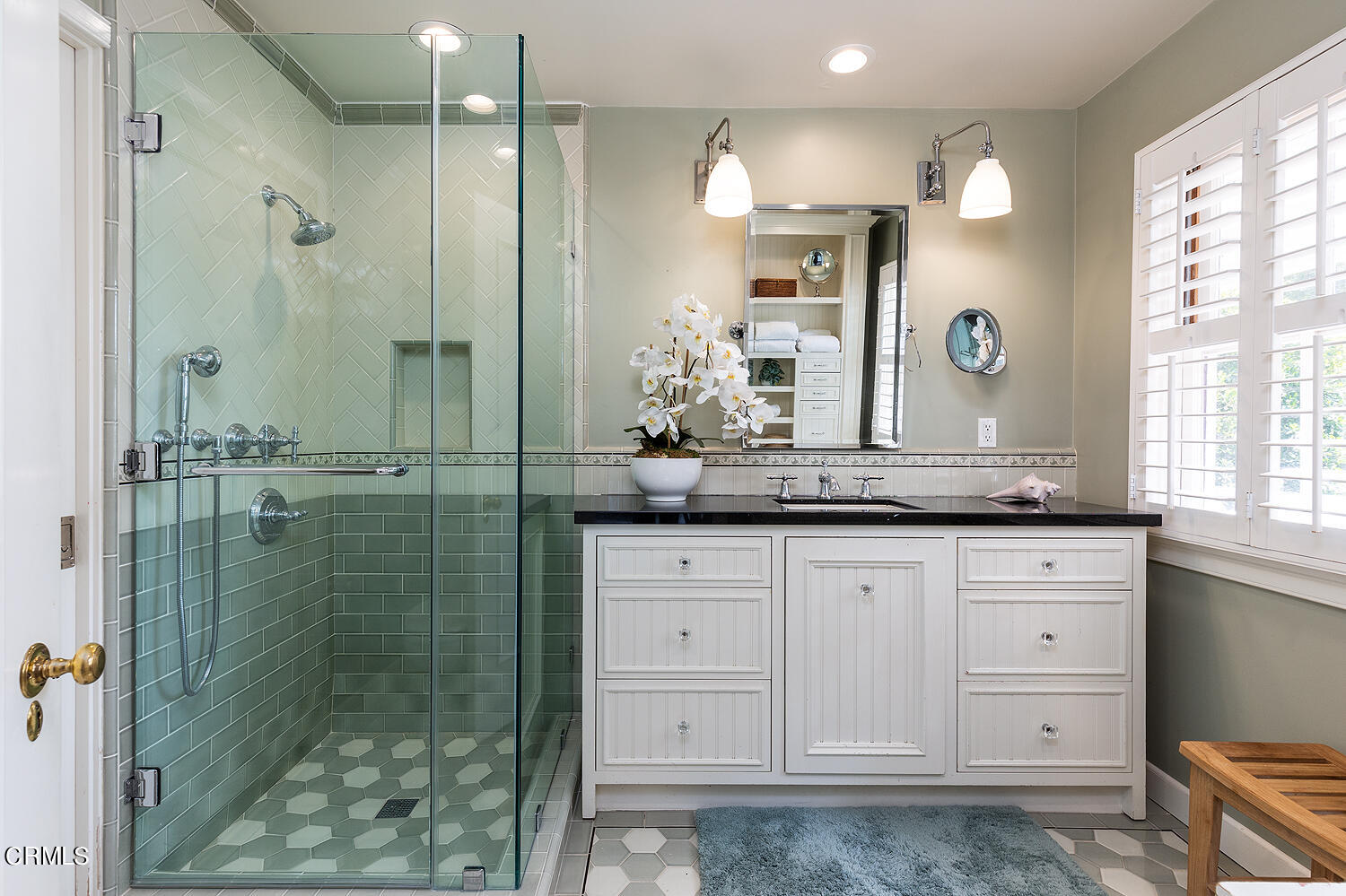 780 Huntington Circle Pasadena, CA 91106 - Photo 27 of 55 a bathroom with a granite countertop sink a mirror a shower and vanity