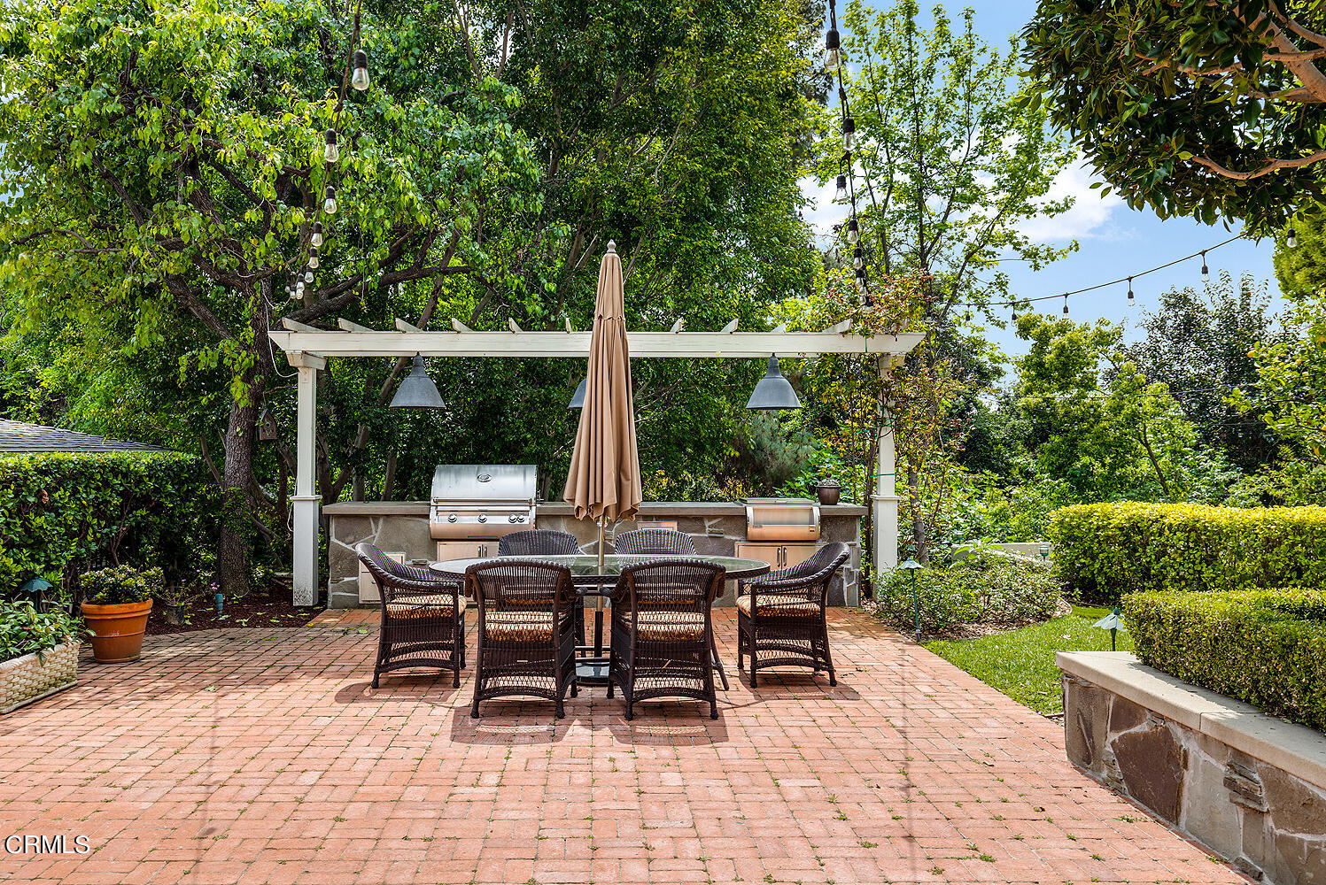 780 Huntington Circle Pasadena, CA 91106 - Photo 45 of 55 a table and chairs with potted plants and large trees