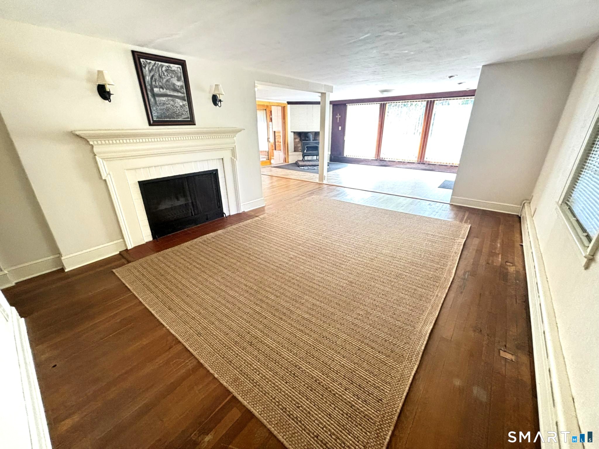 44 Summit Road Prospect, CT 06712 - Photo 12 of 40 a view of an empty room with wooden floor and a fireplace