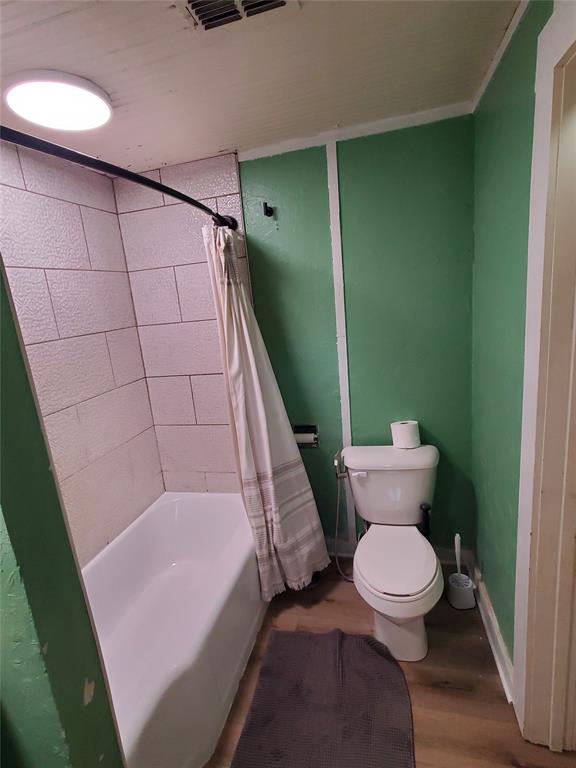 300 North Church Street Decatur, TX 76234 - Photo 11 of 19 a bathroom with a toilet and a shower