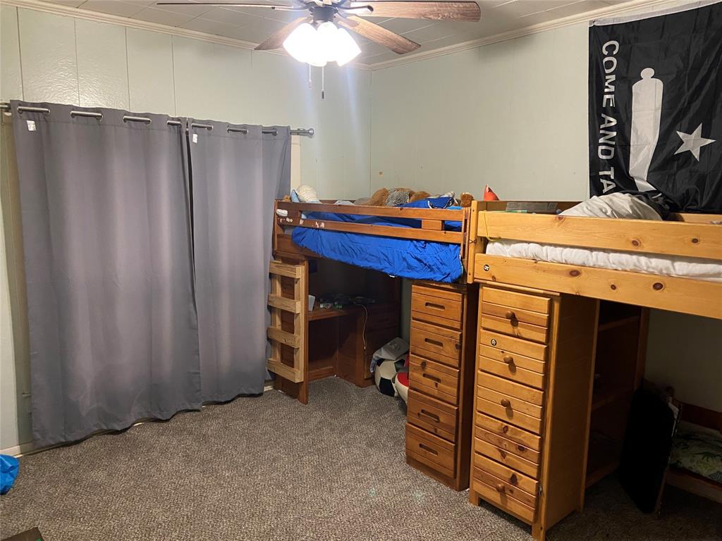 300 North Church Street Decatur, TX 76234 - Photo 13 of 19 a room that has a bed and a dresser