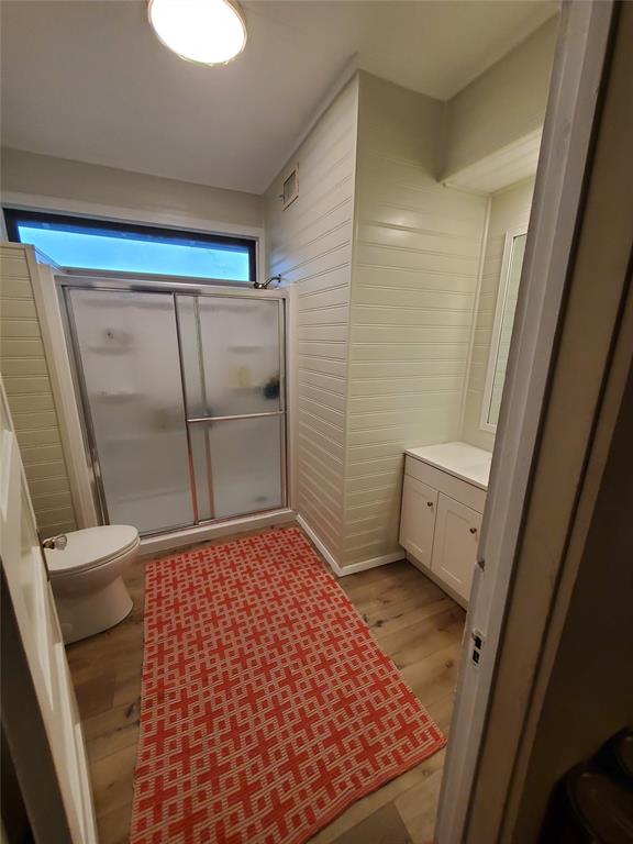 300 North Church Street Decatur, TX 76234 - Photo 16 of 19 a bathroom with a sink a toilet a mirror and shower