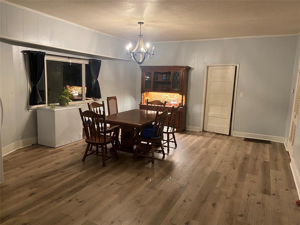 300 North Church Street Decatur, TX 76234 - Photo 5 of 19 a view of a dining room with furniture and chandelier