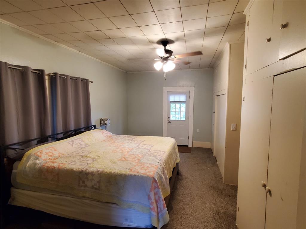300 North Church Street Decatur, TX 76234 - Photo 9 of 19 a bedroom with a bed and a window
