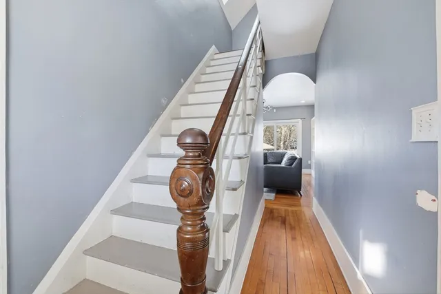a view of entryway and hall with wooden floor