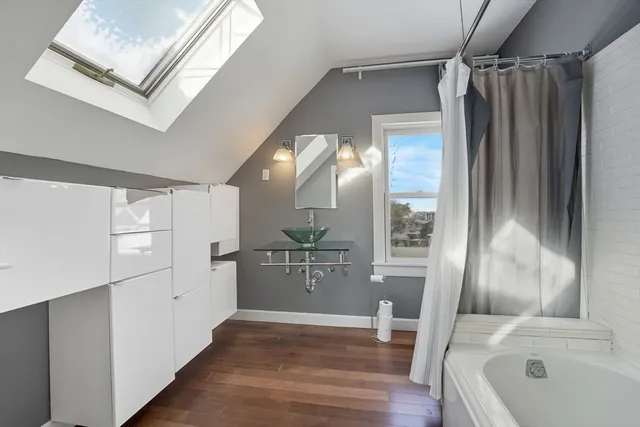 a bathroom with a bathtub and a walk in closet