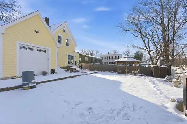 a view of a house with a snow in the yard