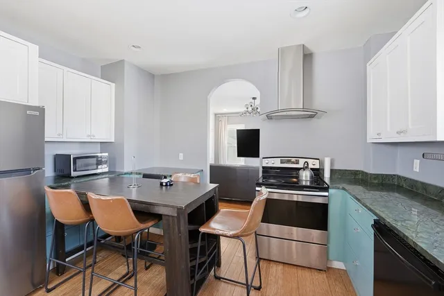 a kitchen with stainless steel appliances a stove a sink a microwave and a refrigerator