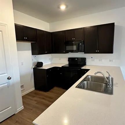 a kitchen with a sink and cabinets