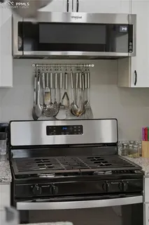a stove top oven sitting inside of a kitchen