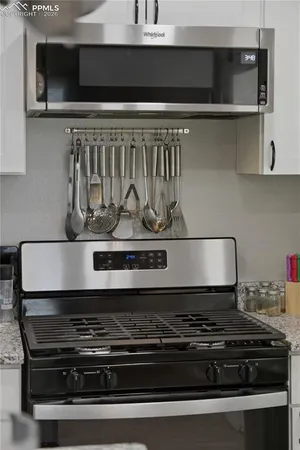 a stove top oven sitting inside of a kitchen