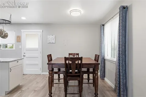 a view of a dining room with furniture and window