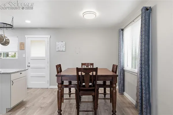 a view of a dining room with furniture and window