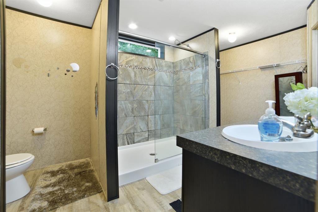 127 Almond Road Minden, LA 71055 - Photo 14 of 25 a bathroom with a sink a toilet and shower