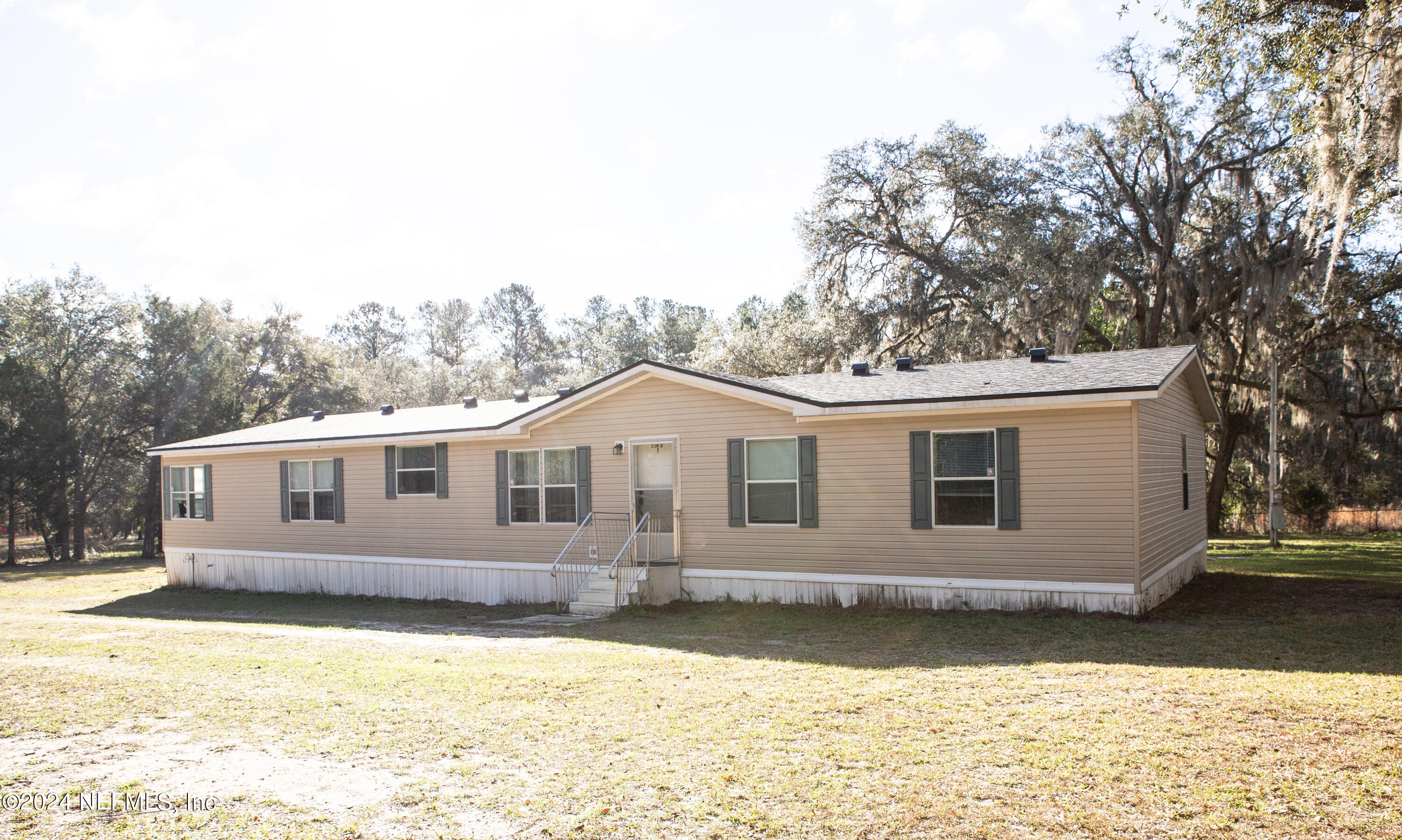 5518 Long Branch Cemetery Road Jacksonville, FL 32234 - Photo 1 of 22 a front view of a house with a yard