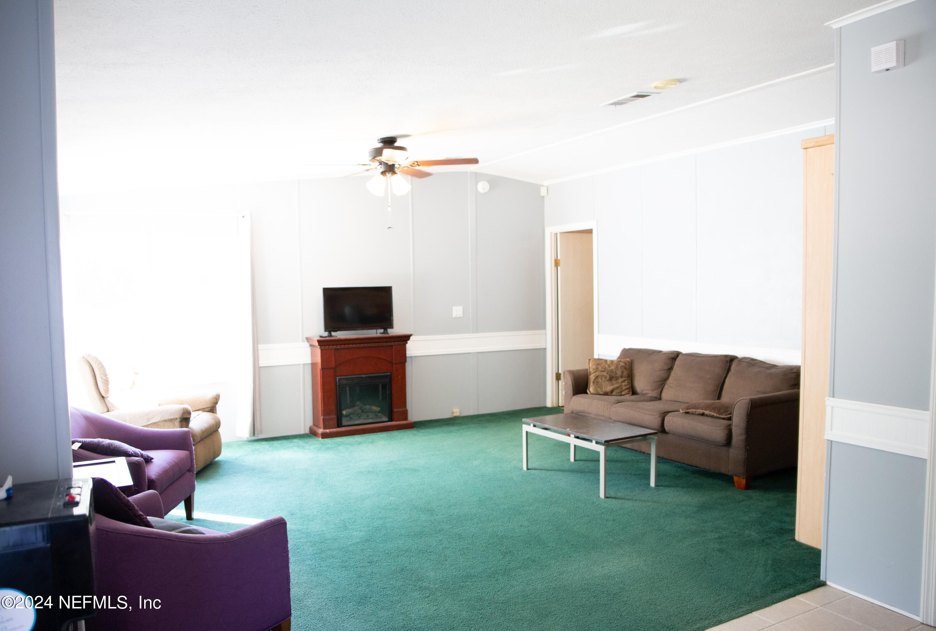 5518 Long Branch Cemetery Road Jacksonville, FL 32234 - Photo 12 of 22 a living room with furniture and a flat screen tv