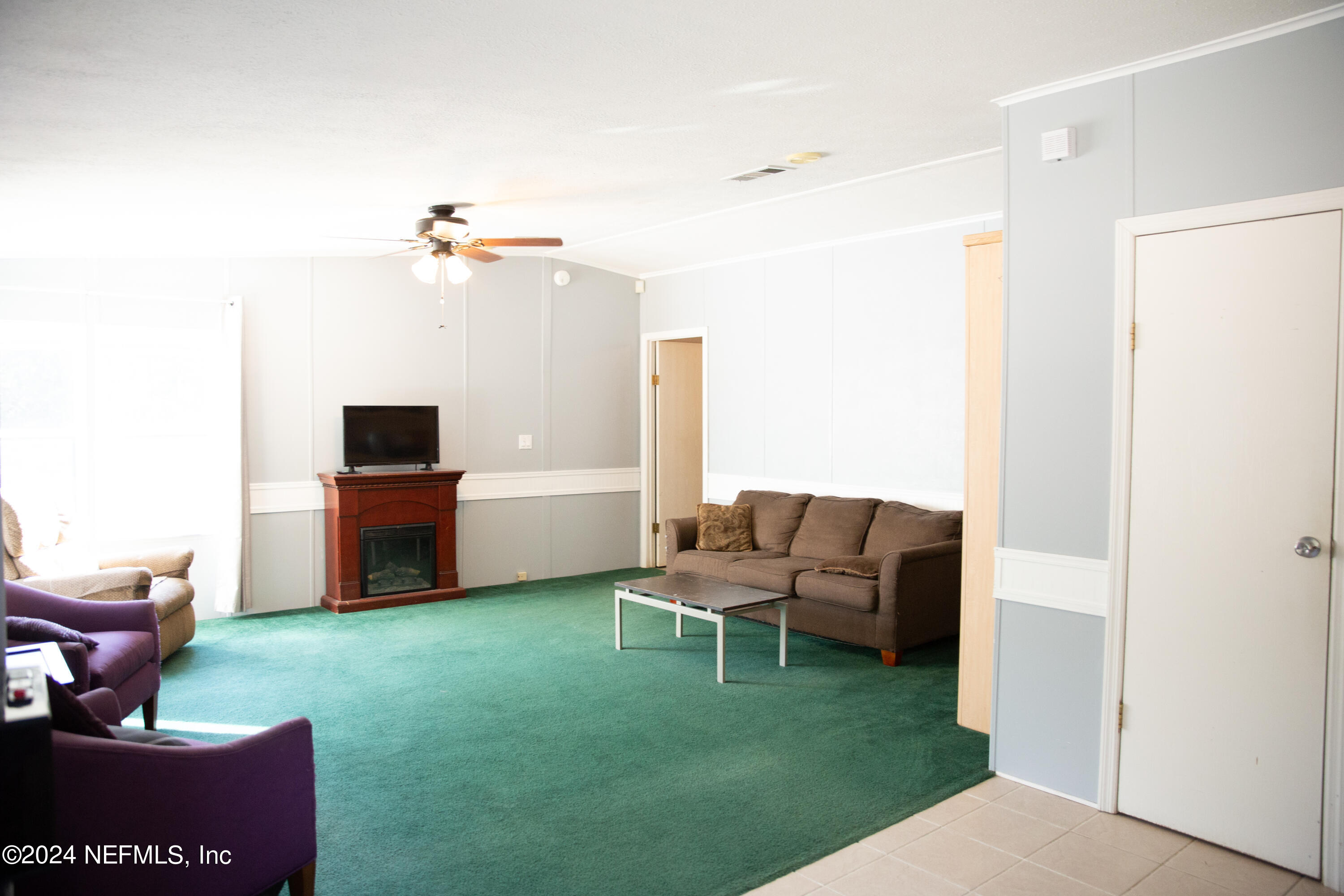 5518 Long Branch Cemetery Road Jacksonville, FL 32234 - Photo 13 of 22 a living room with furniture and a yard