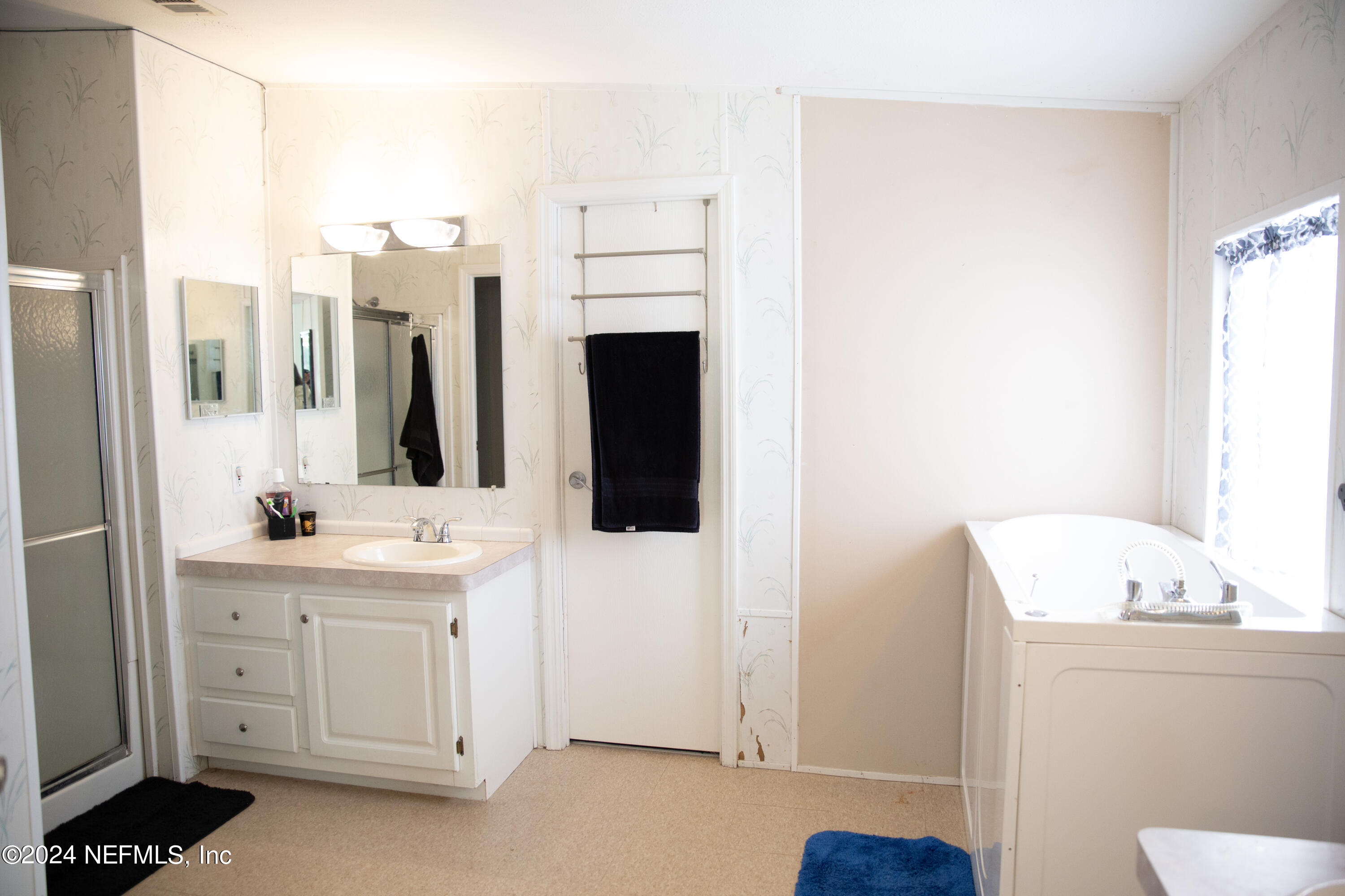 5518 Long Branch Cemetery Road Jacksonville, FL 32234 - Photo 16 of 22 a bathroom with a double vanity sink and a mirror