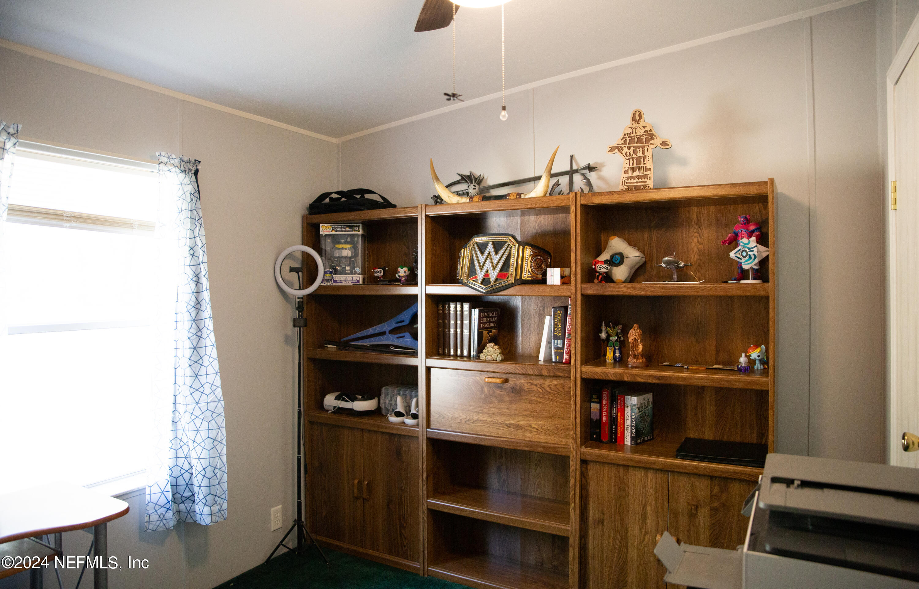 5518 Long Branch Cemetery Road Jacksonville, FL 32234 - Photo 18 of 22 a shelf with books and knick knacks on it