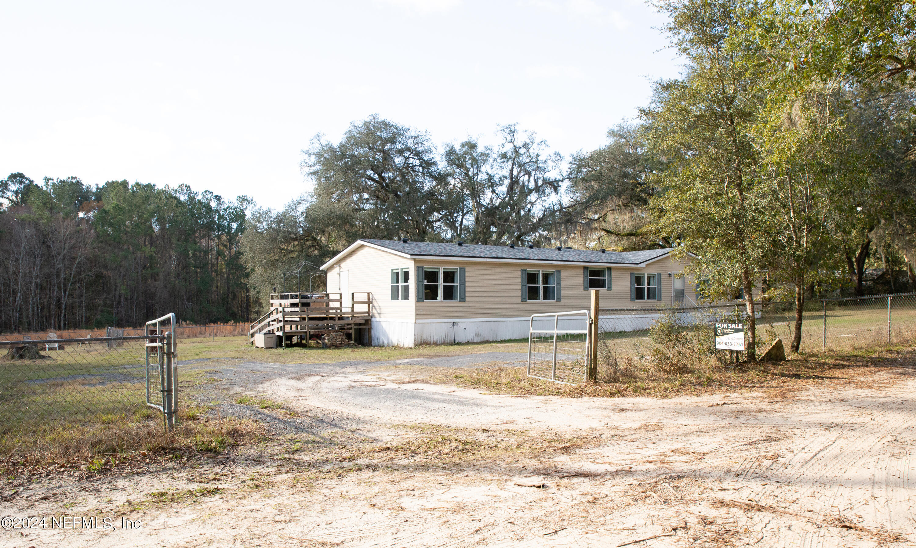 5518 Long Branch Cemetery Road Jacksonville, FL 32234 - Photo 21 of 22 a front view of a house with a yard and garage