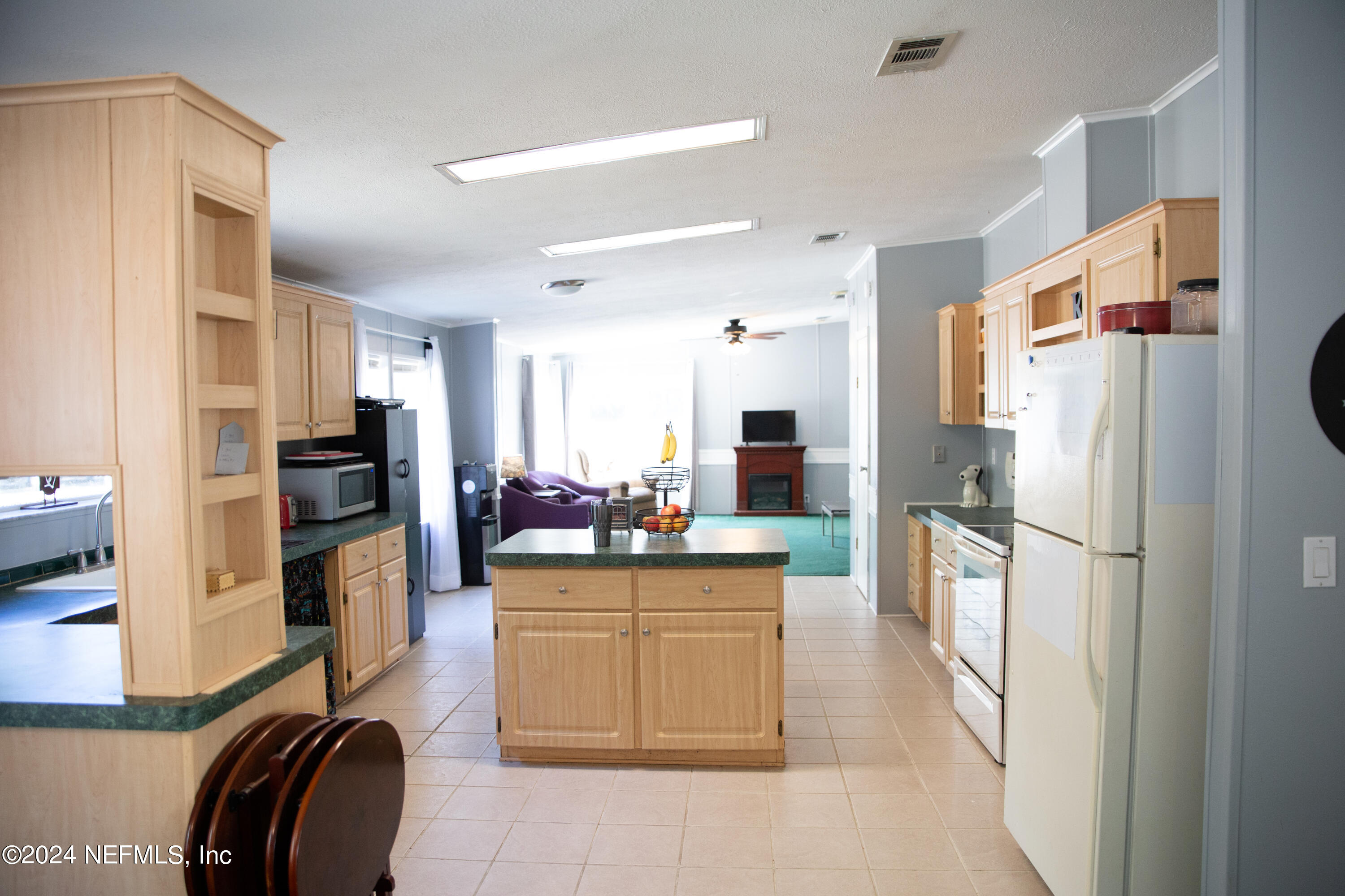 5518 Long Branch Cemetery Road Jacksonville, FL 32234 - Photo 7 of 22 a kitchen with a refrigerator a stove top oven a sink and dishwasher