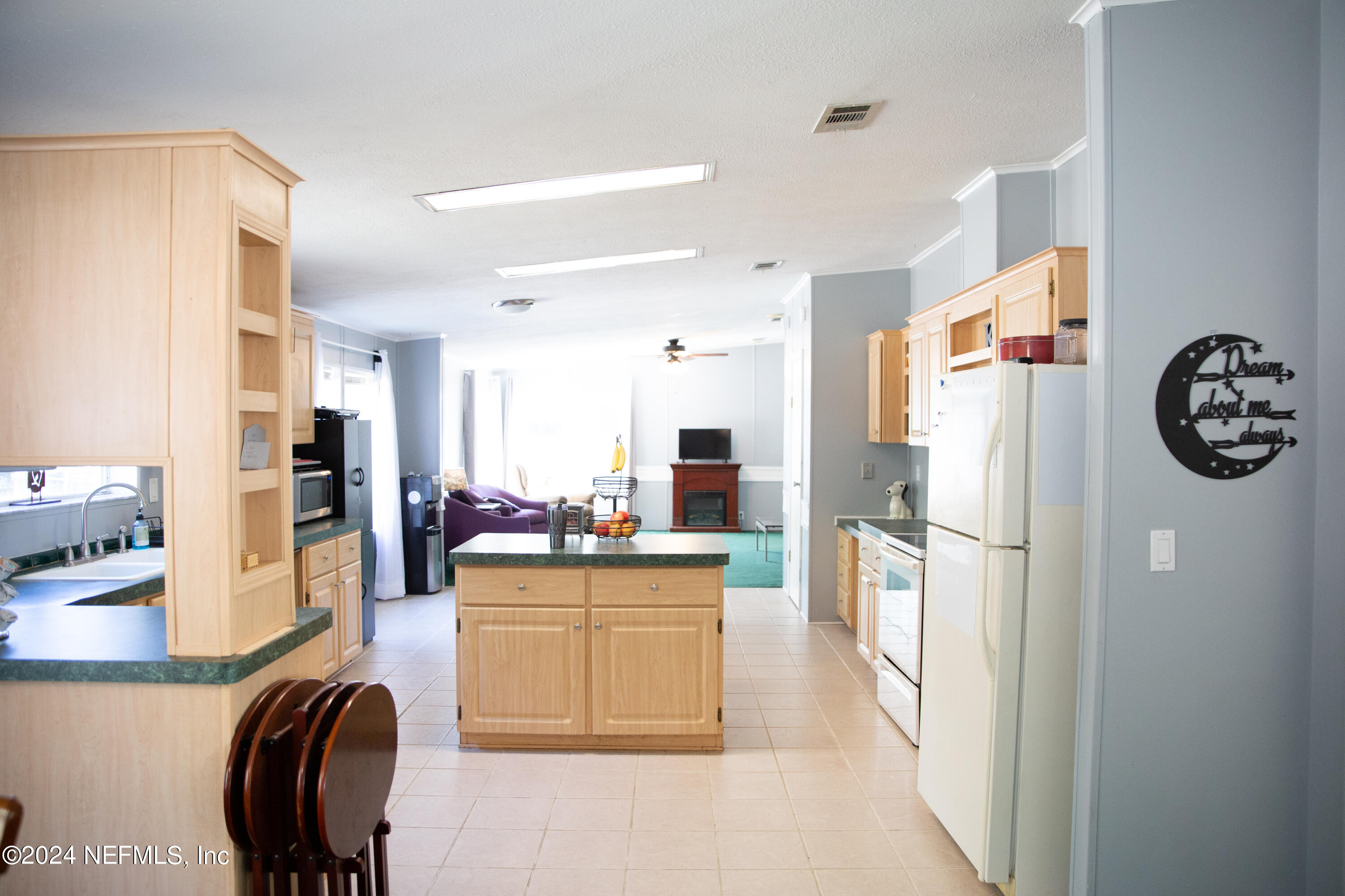 5518 Long Branch Cemetery Road Jacksonville, FL 32234 - Photo 8 of 22 a kitchen with stainless steel appliances a refrigerator a stove a dining table and chairs