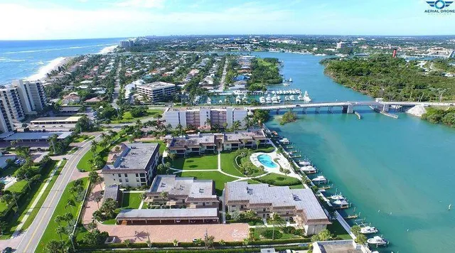 an aerial view of house with yard swimming pool and ocean view
