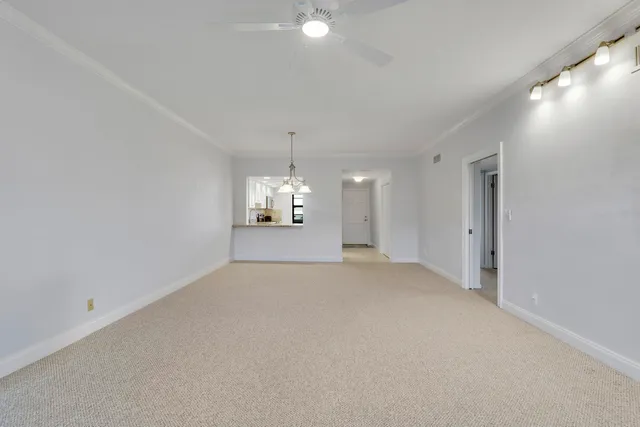 a view of an empty room with a chandelier
