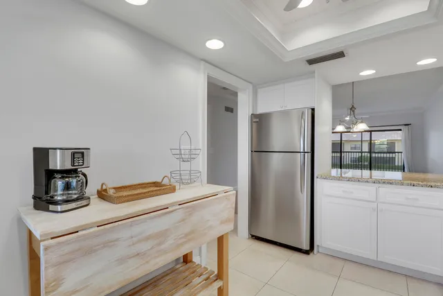 a kitchen with a refrigerator and a sink