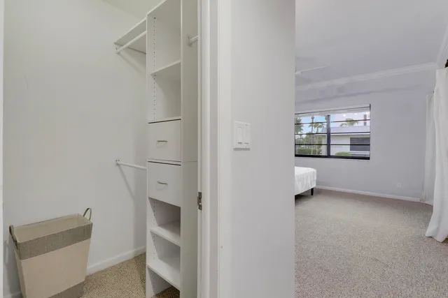 a view of an empty room with a fireplace and a window