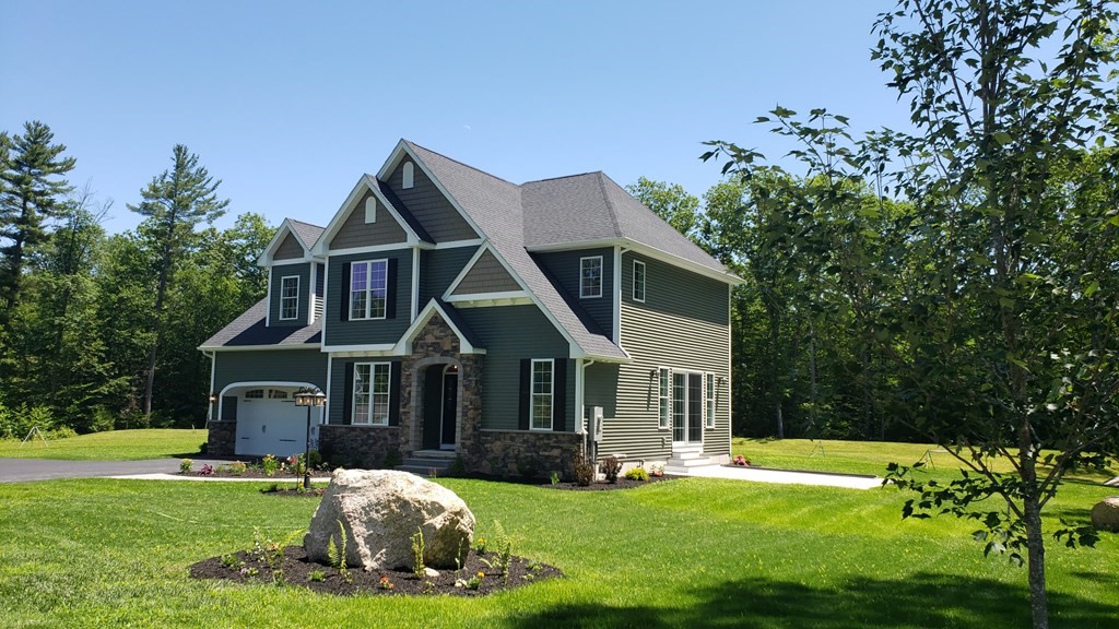 6 Quigley Road Southampton, MA 01073 - Photo 2 of 24 a front view of a house with a garden and porch