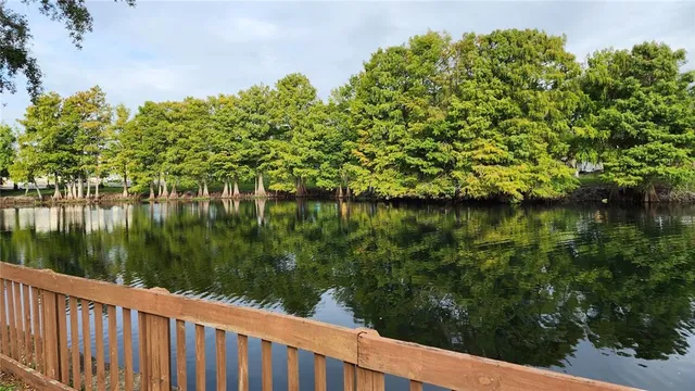 front view of a house with a yard and potted plants